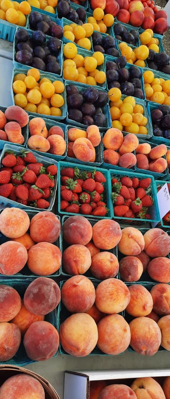 a display in a grocery store filled with lots of fruit