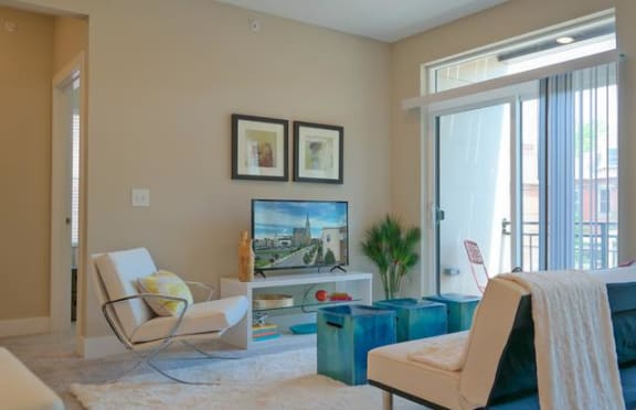 a living room filled with furniture and a flat screen tv