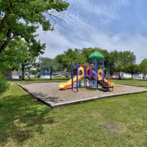 a playground in a park with a blue sky