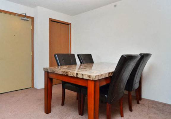 a dining room and kitchen with a table and chairs
