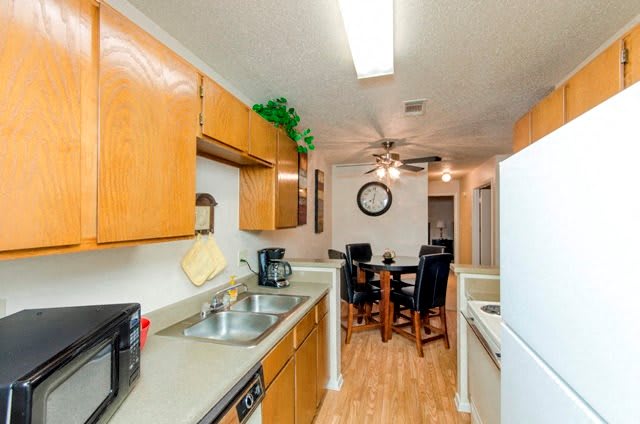 City Pines Apartment Homes kitchen with wood cabinetry - Longview, TX