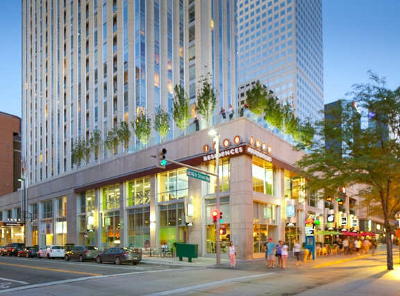 A building with a green sign on the front.