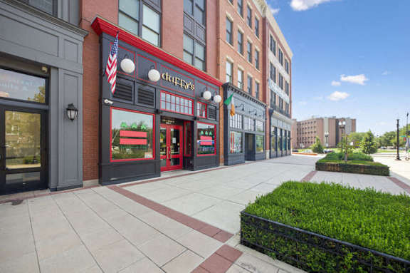 a sidewalk in front of a building on a city street
