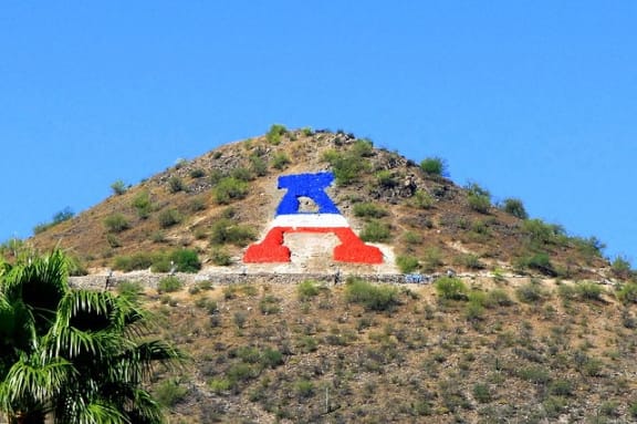a large flag painted on the side of a hill