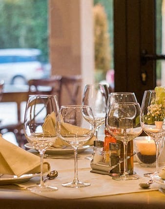 a table set up with wine glasses and napkins