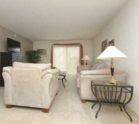 a living room with a couch and a table and a television