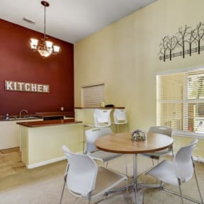 a kitchen with a table and chairs next to a door