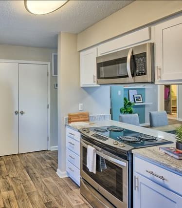 a kitchen with a stove top oven next to a sink