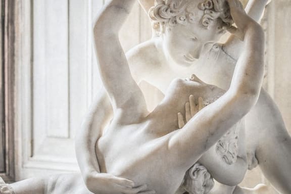 a statue of a woman holding her hand on her abdomen
