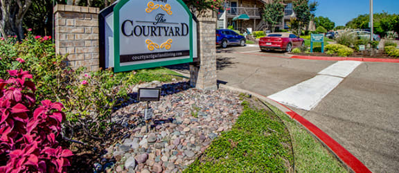 Main entrance to The Courtyard Apartments in Garland TX