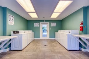 laundry room with washers, dryers, and folding stations