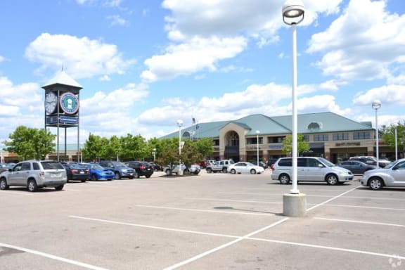 a parking lot with a clock tower in the background