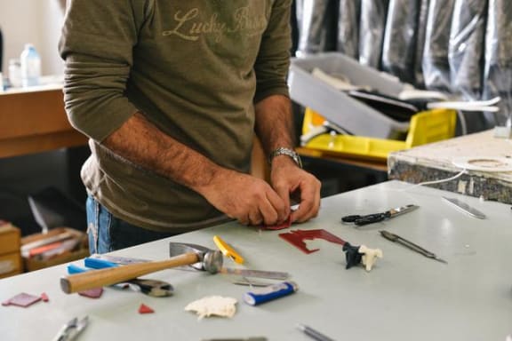 a man is working on a project at a table