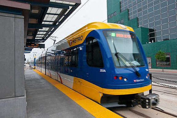 A blue and yellow train is on the tracks.