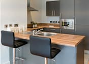 Thumbnail 2 of 2 - a kitchen with stainless steel appliances and a wooden counter top