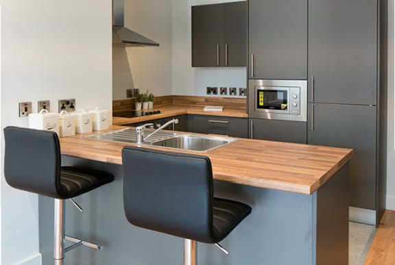 a kitchen with stainless steel appliances and a wooden counter top