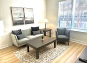 Thumbnail 4 of 13 - a living room with a couch and a table