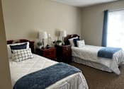 Thumbnail 3 of 9 - Two twin beds with blue blankets in a room with two nightstands.