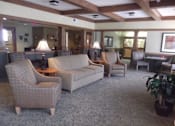 Thumbnail 2 of 3 - A living room with a couch, chair, and table.