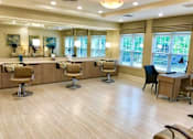 Thumbnail 4 of 5 - A spacious room with wooden floors and multiple chairs and tables.
