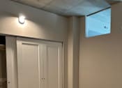 Thumbnail 7 of 18 - A white cabinet with a skylight above it.