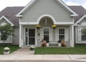Thumbnail 1 of 4 - a white house with a front porch and a sidewalk