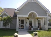 Thumbnail 2 of 4 - the front of a house with a porch and a walkway