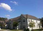 Thumbnail 4 of 4 - a gray house with a gray roof and a blue sky