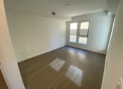 Thumbnail 24 of 41 - Bedroom with wood flooring and windows at unit 203, 739 South Ogden Drive.