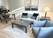 Thumbnail 6 of 13 - a living room with a couch and a table
