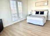Thumbnail 7 of 13 - a bedroom with a bed and two windows