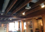 Thumbnail 7 of 8 - A room with wooden beams on the ceiling.