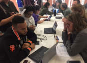Thumbnail 7 of 13 - Residents signing up for programs at community event