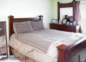 Thumbnail 16 of 36 - Large carpeted bedroom with four poster bedframe and mattress with grey bedding