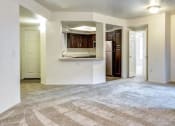 Thumbnail 14 of 24 - Ingleside Apartments Living Room with wall to wall carpet and kitchen by the front door