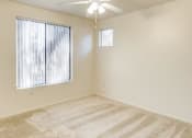 Thumbnail 17 of 24 - Ingleside Apartments bedroom with wall to wall carpet, a ceiling fan, and large window