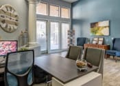 Thumbnail 8 of 24 - Ingleside Apartments Leasing Office desk with side chairs and blue accent wall