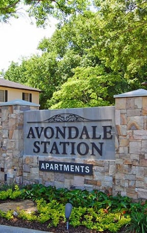 a sign  in front of a building at Avondale Station Apartments in Decatur, GA