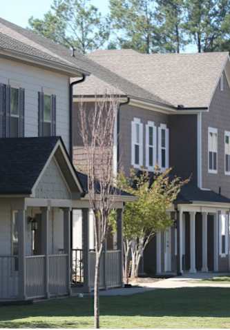 a row of houses with trees in front of them