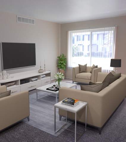 A living room with a large couch, a chair, and a coffee table.