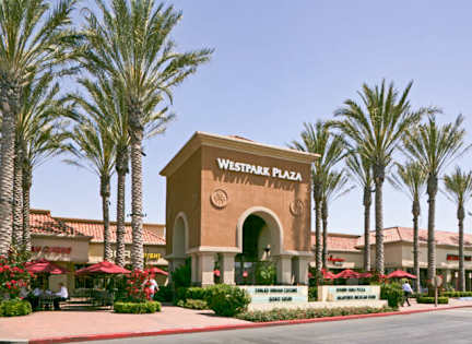 The entrance to Westpark Plaza is framed by palm trees.