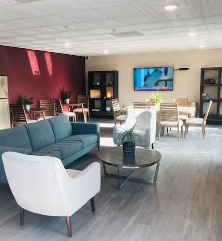a living room filled with furniture and a flat screen tv