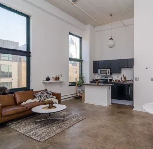 a living room with a couch and a kitchen