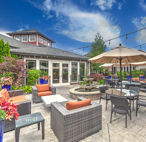 a patio with tables and chairs and umbrellas at BELLA SONOMA, Fife, 98424