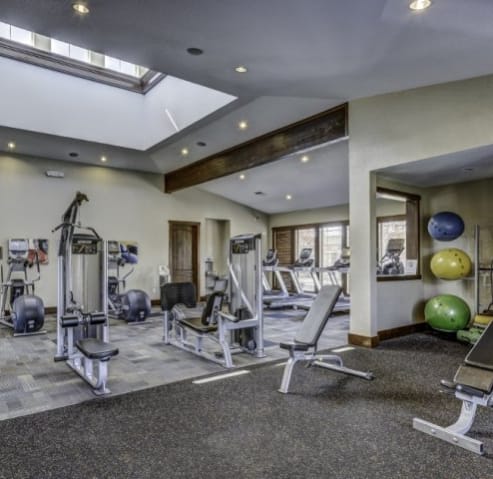 a gym with a lot of weights and exercise equipment at BELLA SONOMA, Fife, WA