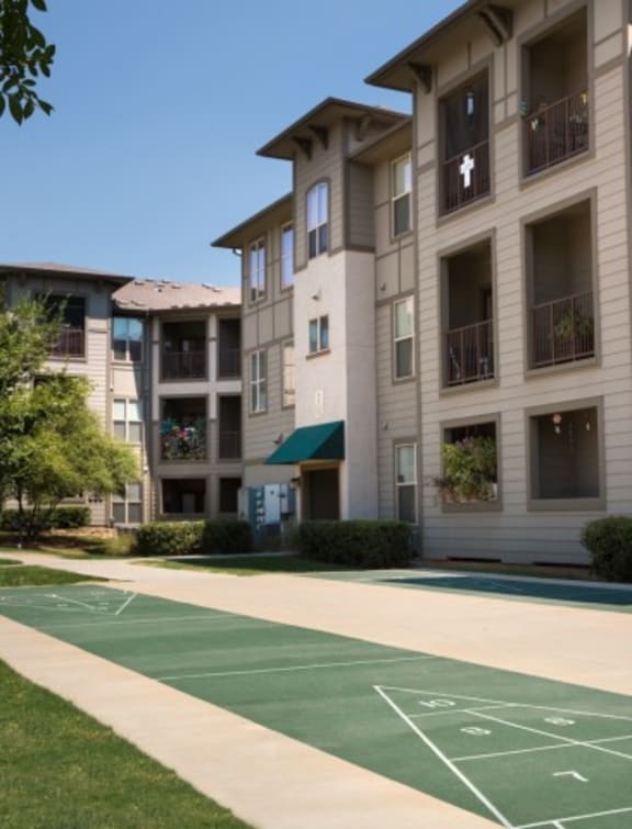a basketball court in front of an apartment building