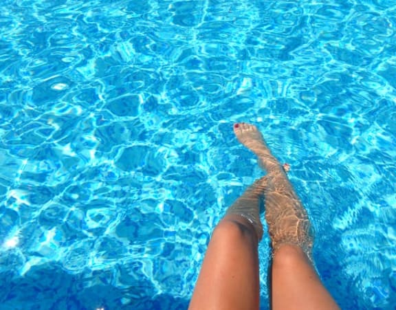 a persons legs in a swimming pool