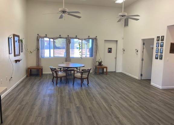 A room with a table and chairs in it.