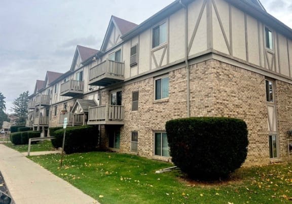 a brick building with a sidewalk in front of it