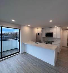 a kitchen and living room with a large window